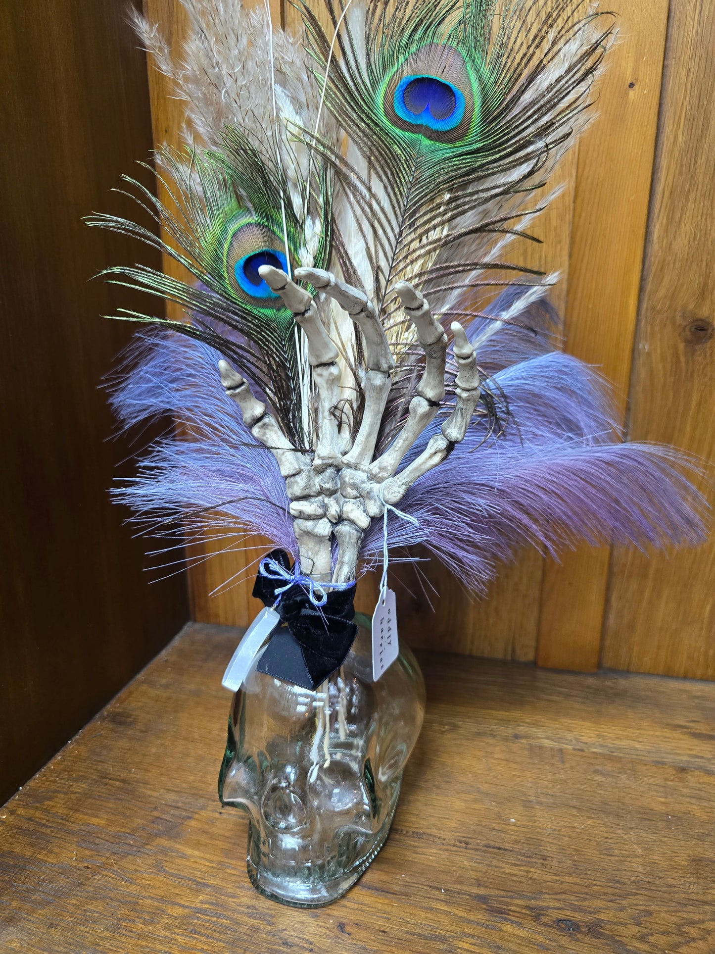 Large glass skull with feathers by Oddly Harriet